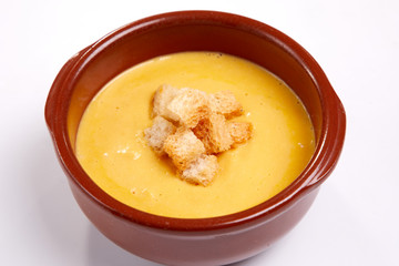 pumpkin cream soup with croutons on the white background