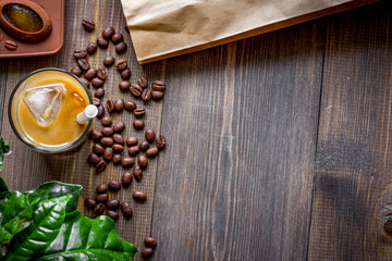 coffee with ice in glass on wooden background top view