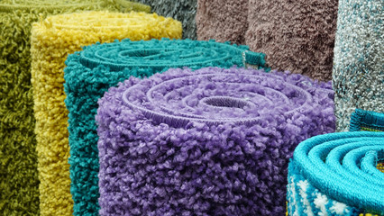 Carpets variety selection rolled up rugs shop store