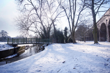 Bridge over stream with railway arches in distance, Southgate, London.