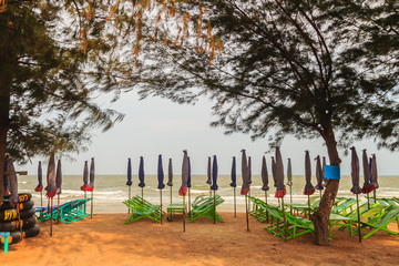 Canvas umbrellas and chairs on the beach at Chao Samran beach, Phetchaburi, Thailand.