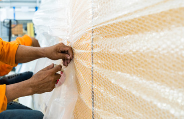 Closeup of man packing parcels with sticky tape at warehouse