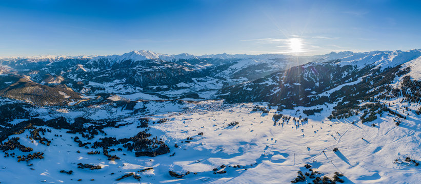 Laax Panorama of the village in the winter mountains covered with snow. Winter landscape. Sun shining. The concept of freedom and solitude.
