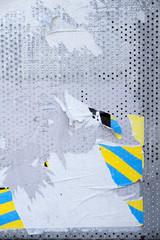 Torn poster on metal shutter