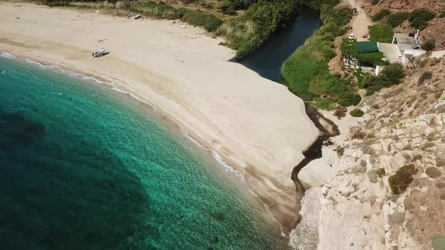 Aerial dorne bird's eye view video of iconic beach of Potami or River with turquoise clear waters, South Evia island, Greece