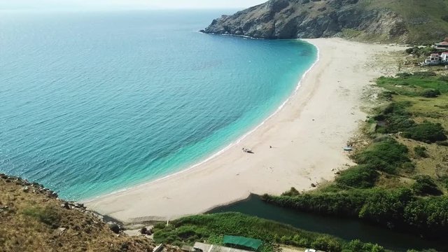 Aerial dorne bird's eye view video of iconic beach of Potami or River with turquoise clear waters, South Evia island, Greece
