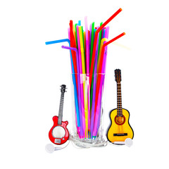 Concept glass beaker with many colorful tubes, headphones and guitars as a musical lifestyle....