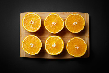 cut orange on wooden background