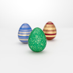 Three Easter egg concept with striped golden decoration