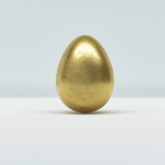 One golden Easter egg on white background