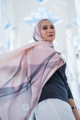 Portrait of happy young woman wearing modern stylish hijab 