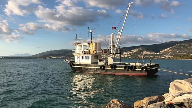 Trawler boat moored at a harbour.