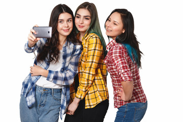 Three happy girls models make selfie. smiling. isolated on white background