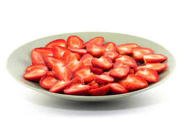 Sliced Strawberries in dish isolated on white background