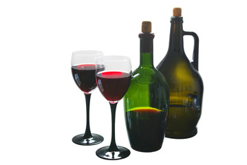 Two glasses of red wine and two bottles