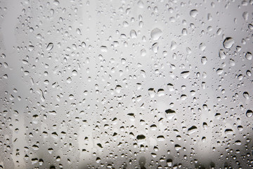 Rain drops on glass of window background.
