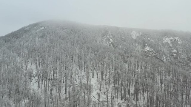 Fog and snow on ground over the Veliki Krs ridge 4K drone video