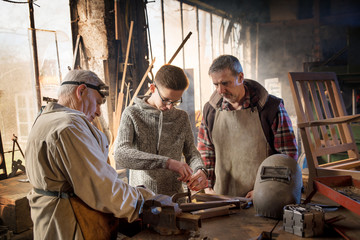 Two craftsmen and their apprentices in their craft workshops 