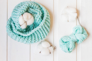 Cotton and yarn ball on the white background. Knitted scarf