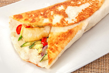 Burritos wraps with beef and vegetables on white plate. Beef burrito, mexican food. burrito