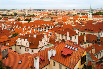 Obraz premium Aerial shot of roofs of houses in Prague, Czech Republic, during a city break in Autumn. Popular European travel destination.
