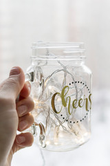 Glass with the garland in the hand