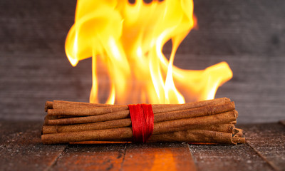 Flames with Cinnamon on a Wooden Table