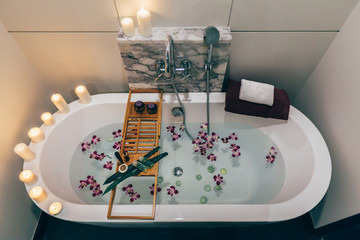 Spa bath with flowers, candles and tray