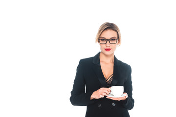 businesswoman in black formal wear with open neckline drinking from cup isolated on white