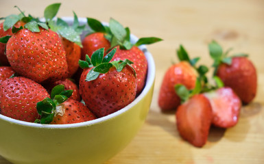 Ripe red strawberries on wooden table