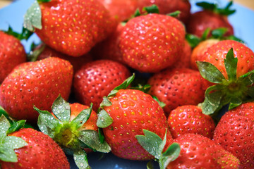 Ripe red strawberries on wooden table