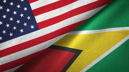 Obraz premium United States and Guyana two flags textile cloth, fabric texture