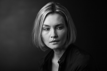 Dramatic black and white portrait of a beautiful woman on a dark background