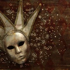 silver elegant traditional venetian mask over dark wooden background