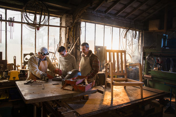 Two craftsmen and their apprentices in their craft workshops 