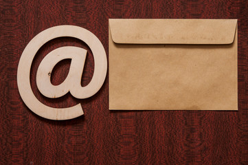 E-mail at symbol and envelope on a desk