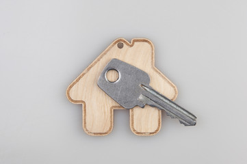 wood percent sign and house shape on white background. The concept of price changes on the real estate market