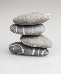 stacked pebbles on white background