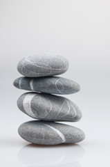 Fototapeta na wymiar stacked pebbles on white background