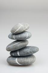 Fototapeta na wymiar stacked pebbles on white background