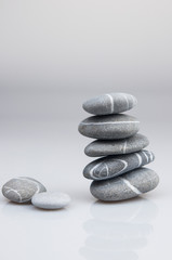 stacked pebbles on white background