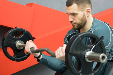 Man in the gym with kettlebells and weights.