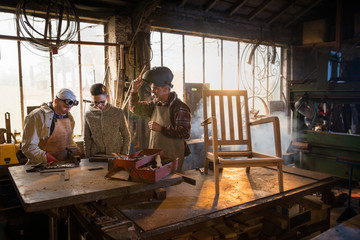 Two craftsmen and their apprentices in their craft workshops 