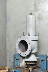 A large gray valve is installed on a test stand in the test room and is tested under high pressure...