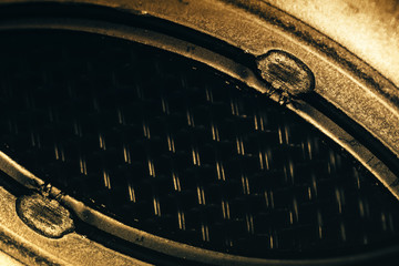 Unusual robotic eye in steampunk style. Empty robot look. Golden background pattern close-up.