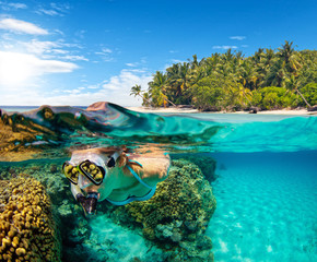 Under and above water view of woman snorkeling.