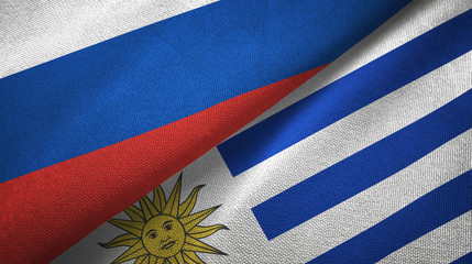 Russia and Uruguay two flags textile cloth, fabric texture