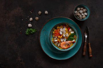 Close up of Seafood pasta Tagliatelle with Clams, shrimps and vegetables