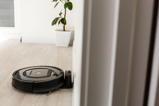 Robot vacuum cleaner return to charging at dock in clean room floor