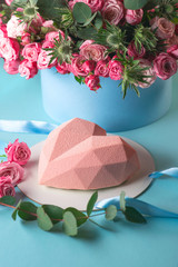 stylish modern design pink heart shaped cake on blue background with roses